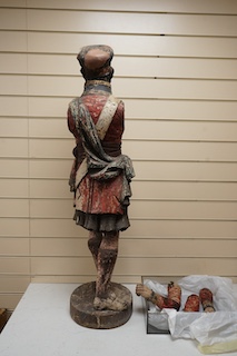 A large 19th century carved and painted Highlander ‘Snuff’ shop advertising figure. 109cm high. Condition - paint work and base weathered, arms detached.